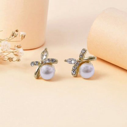 Pearl butterfly stud earrings styled with accessories