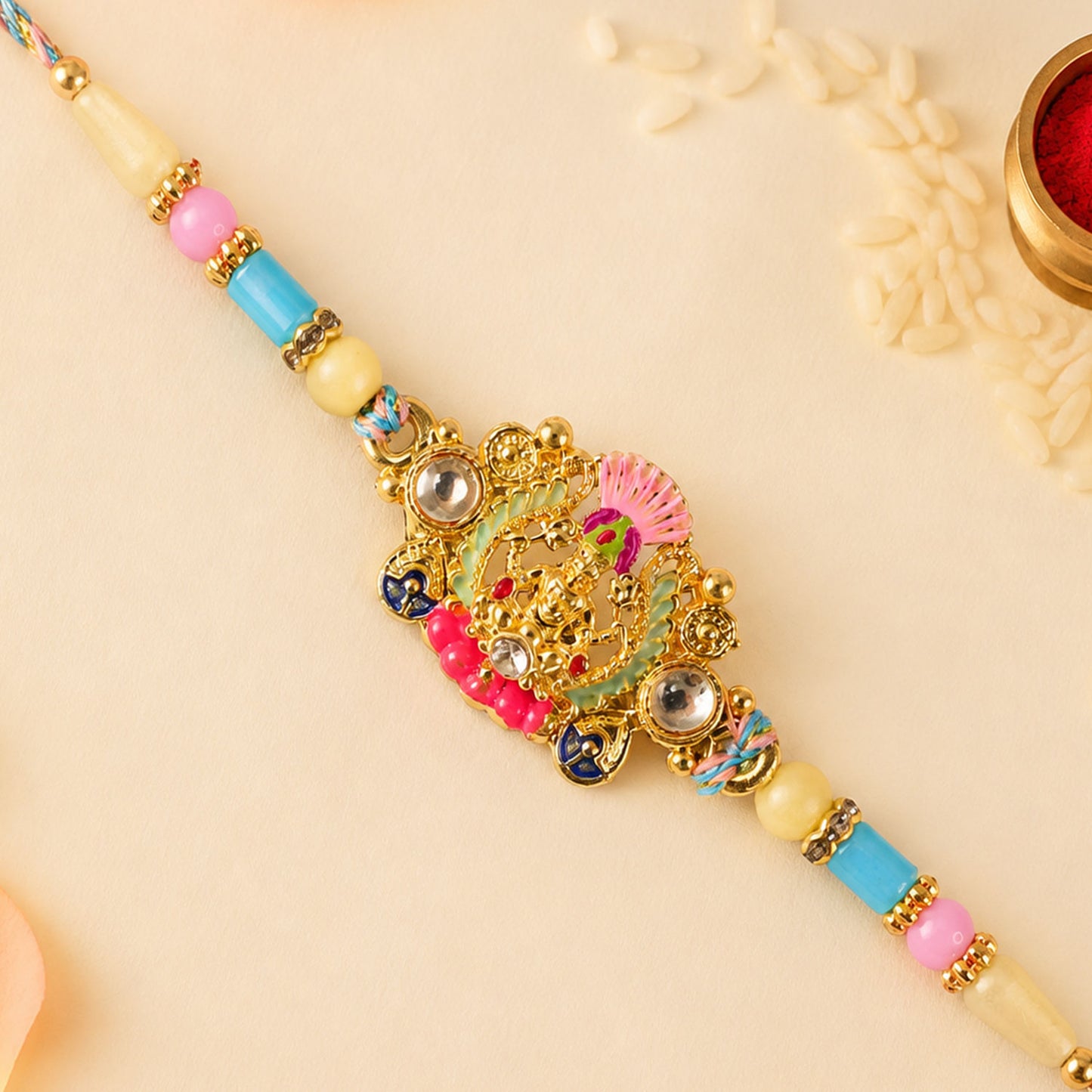 Gold Peacock Kundan Pendant Rakhi with Pastel Beads