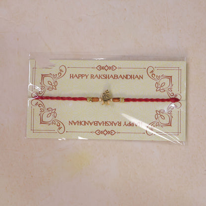 Red Braided Rakhi with Golden Om Pendant and Warm Amber Beads