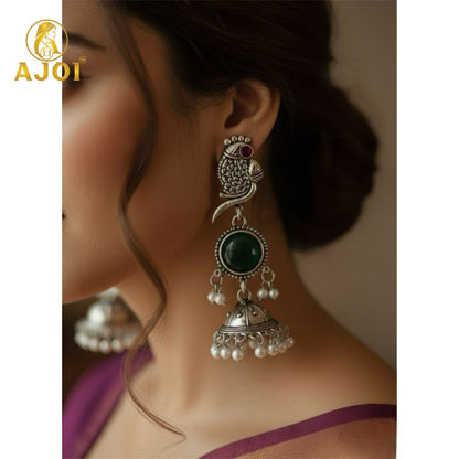 Side view of handcrafted antique silver peacock jhumka earrings with pearl drop detailing