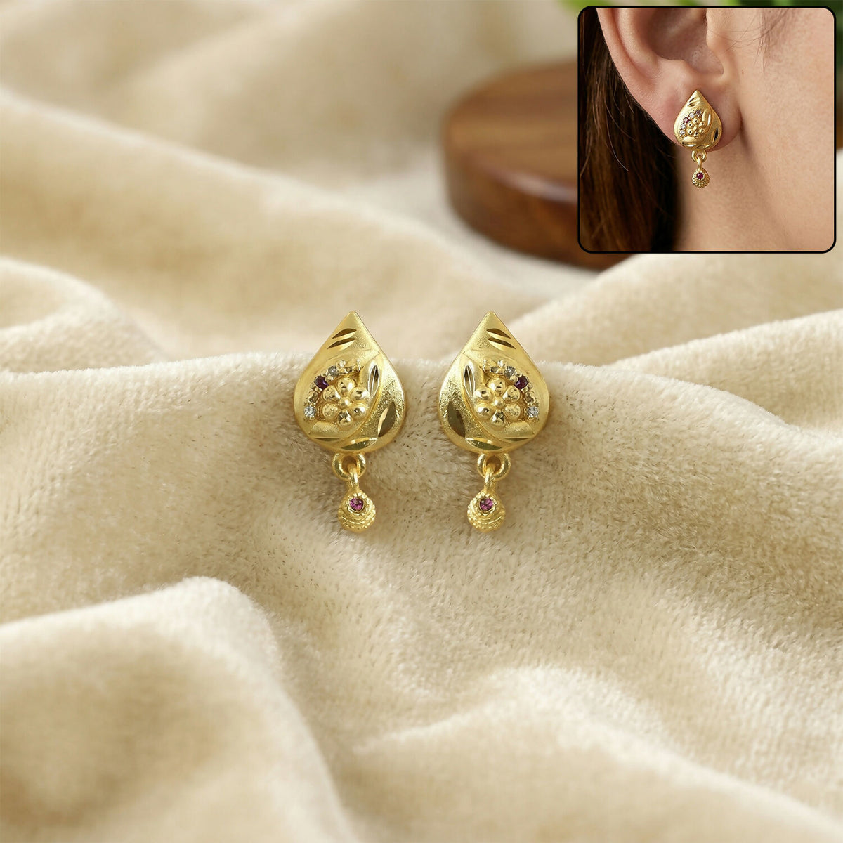 Traditional gold plated geometric drop earrings on model
