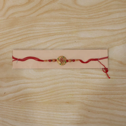 Multicolor Swastik Rakhi with Peach Beads and Navy Backdrop