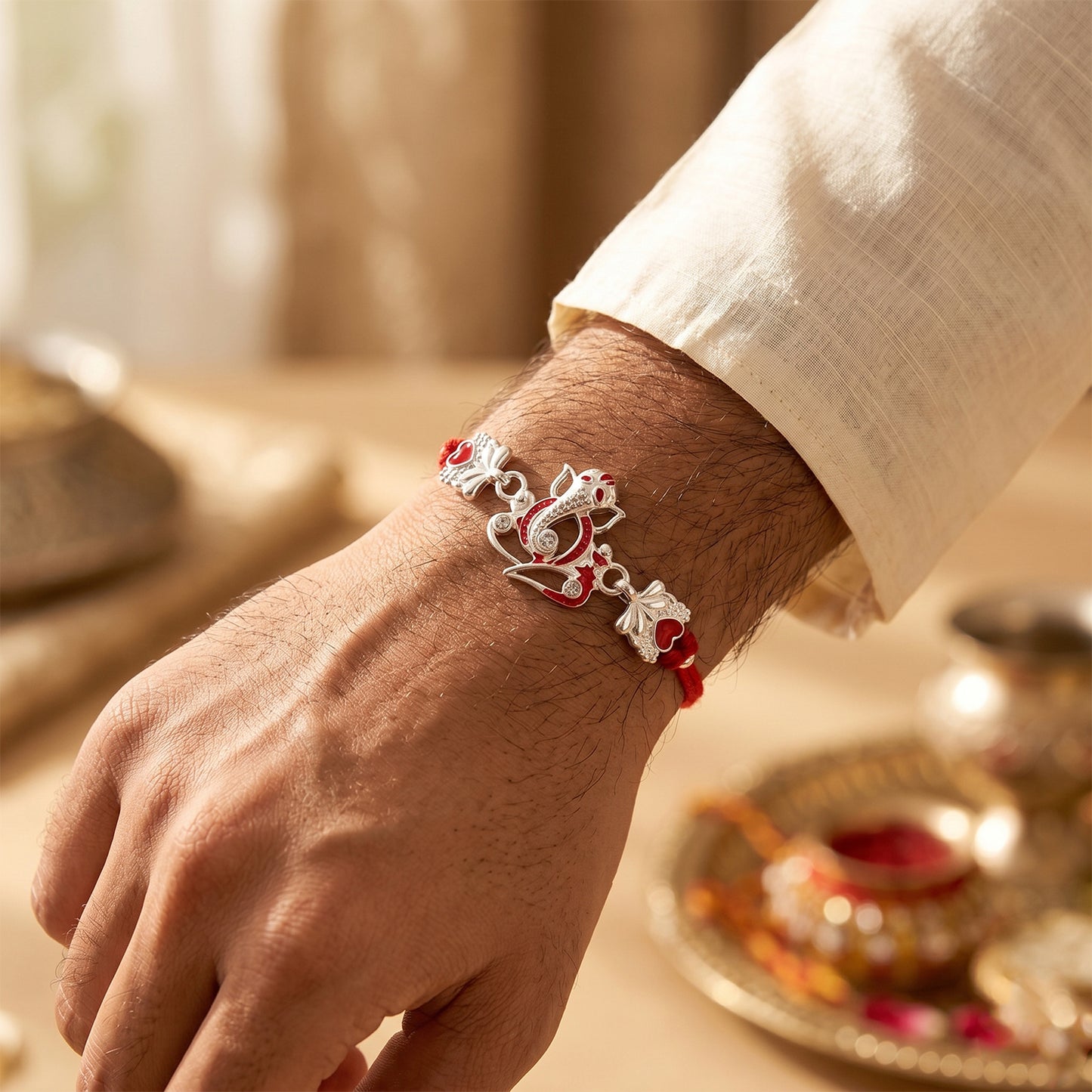 Silver Ganesha Rakhi with Red Stone Hearts and Deep Velvet Look