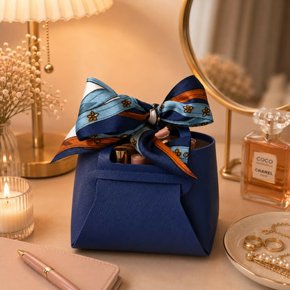 Mini blue handbag organizer with printed bow on a white background