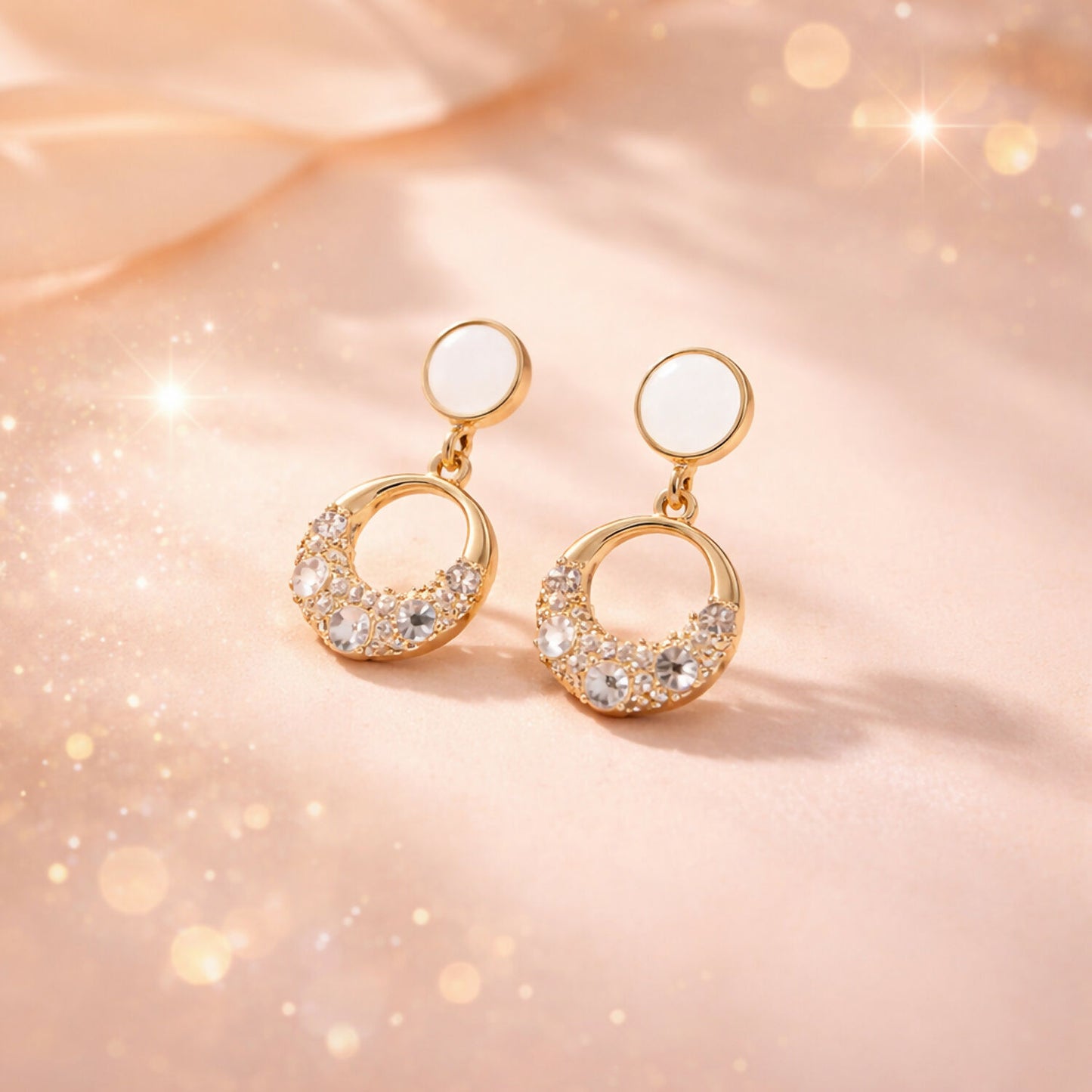 Elegant gold crystal drop earrings displayed on white background