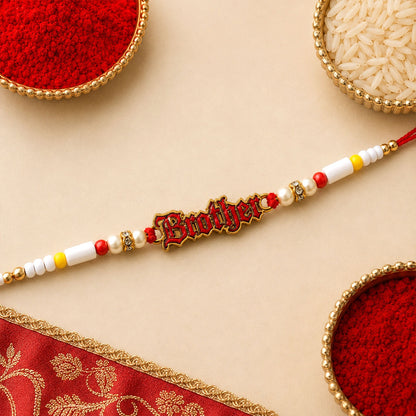 A red and gold "Brother" charm is centered on a string of white, yellow, and pearl beads, with two bowls of red powder and
