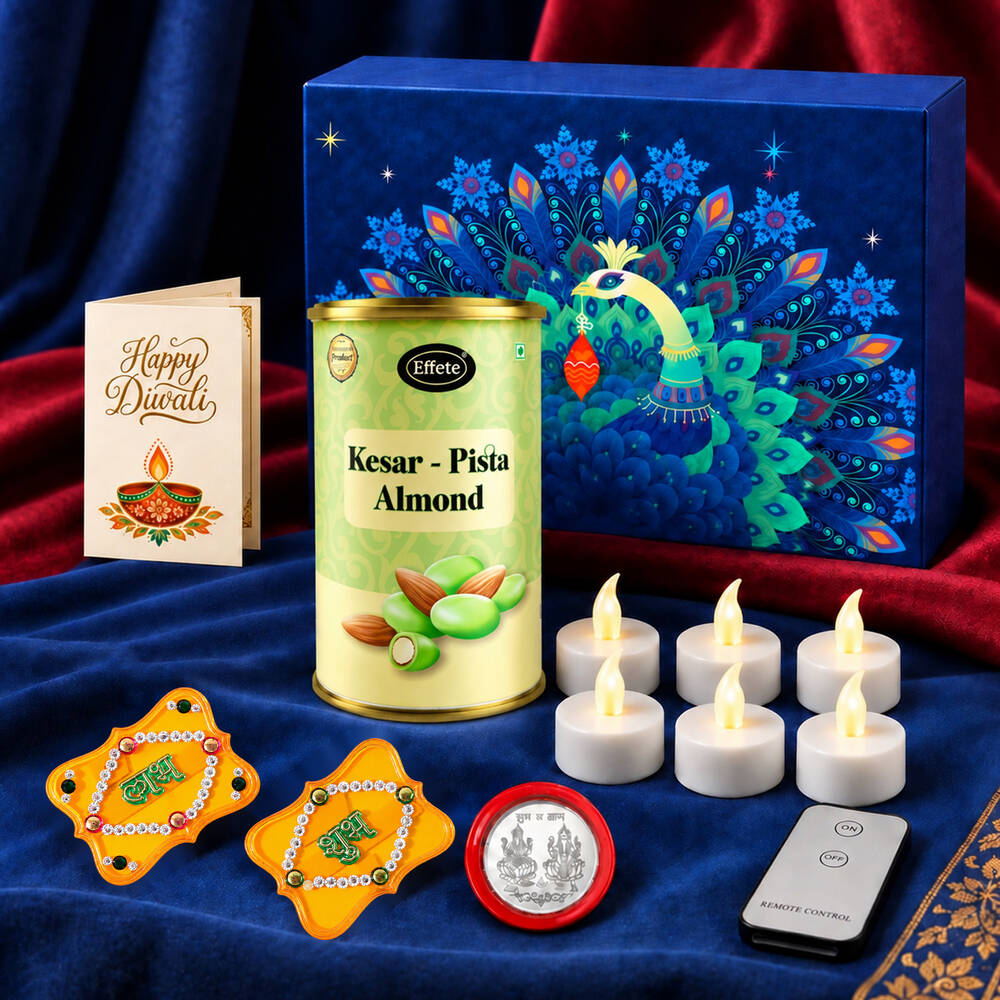 A blue box with a peacock design, a tin of almonds, a Diwali card, LED tealights, gold Shubh-Labh decor, a silver coin, all