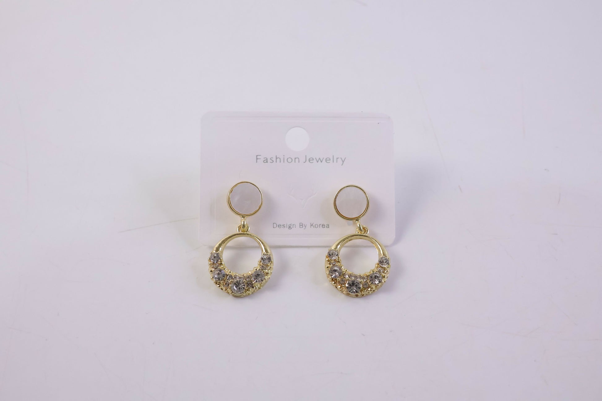 Stylish gold round crystal drop earrings with pearl top in natural light