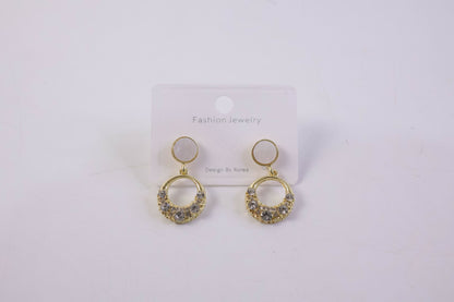 Stylish gold round crystal drop earrings with pearl top in natural light