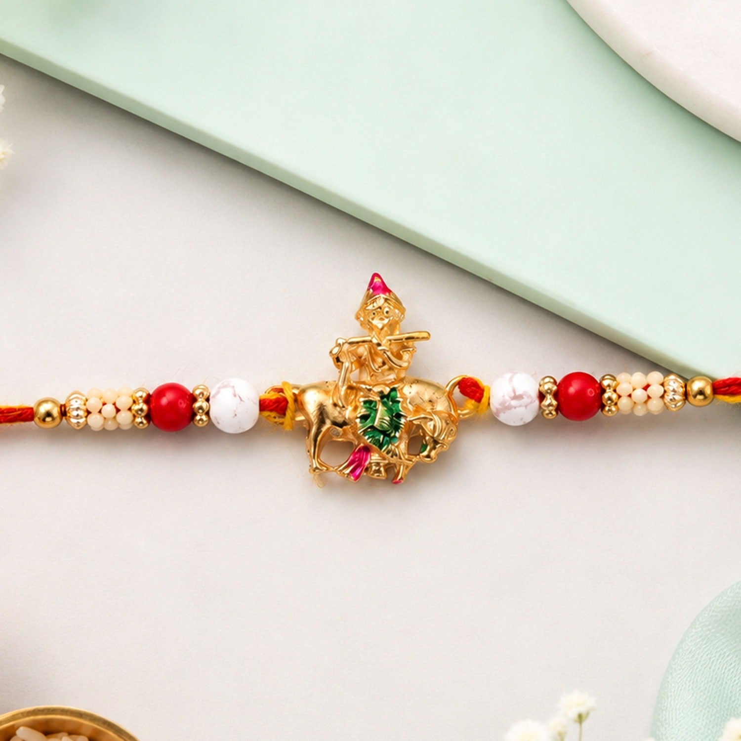 Lord Krishna beaded rakhi for brother, featuring a divine motif and vibrant beads, perfect for Raksha Bandhan celebrations.