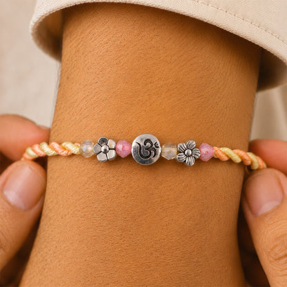 Graceful Pastel Bracelet Rakhi with Silver Centre and Delicate Raksha Bandhan Beauty