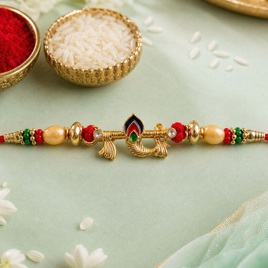 Peacock Feather Rakhi with multicolor beads and gold-tone finish on a white background.