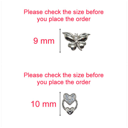 Heart and butterfly silver stud earrings displayed on textured surface