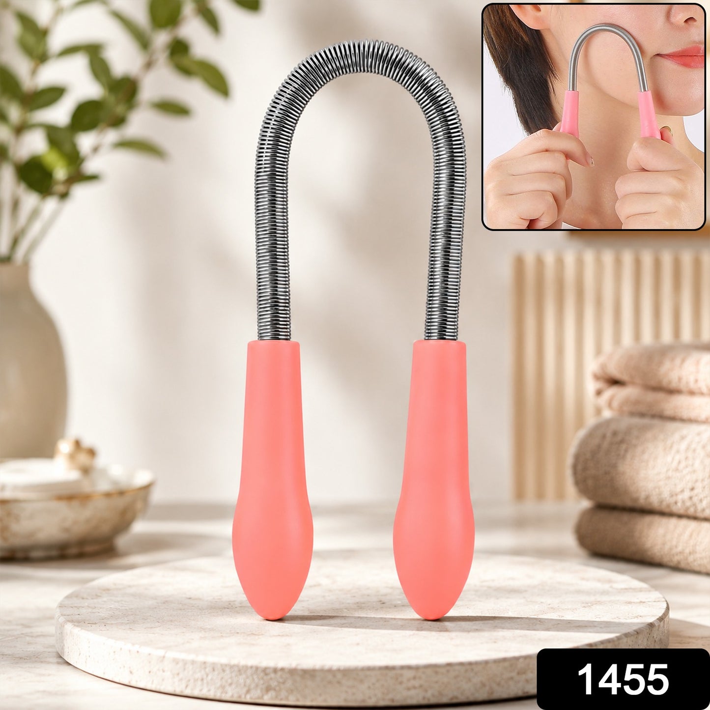 A pink and silver facial hair remover spring tool stands upright on a light stone surface, with a small inset showing it in