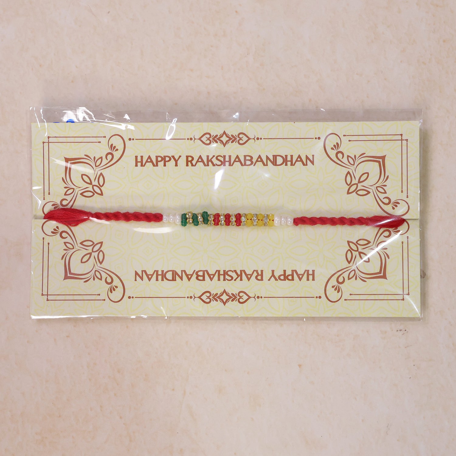 Red Braided Rakhi with Green, Yellow and White Bead Pendant Row