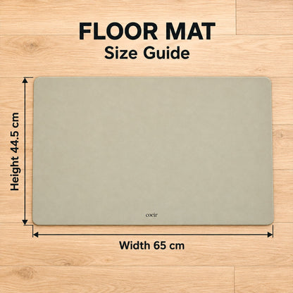 A light beige floor mat with rounded corners on a wooden floor, showing dimensions of 44.5x65 cm.