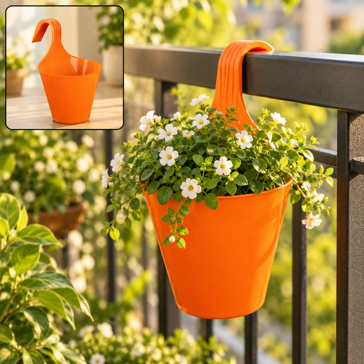 Bright orange plastic hanging planter pot with white flowers on a balcony railing, sunny outdoor setting.