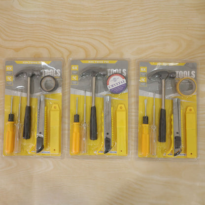 Three identical 6-in-1 household tool kits, each sealed in clear plastic packaging, are laid flat on a light wood grain