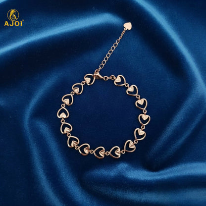 Side view of delicate heart link gold plated bracelet for women
