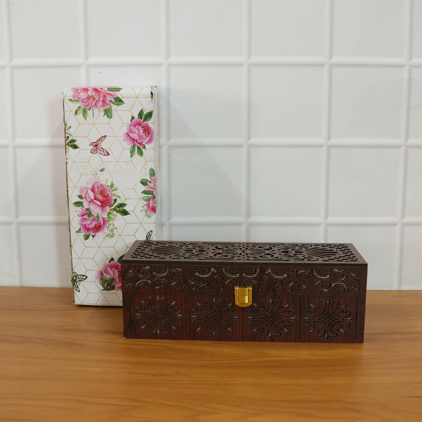 Side view of wooden dry fruit storage box with carved detailing and glass jars