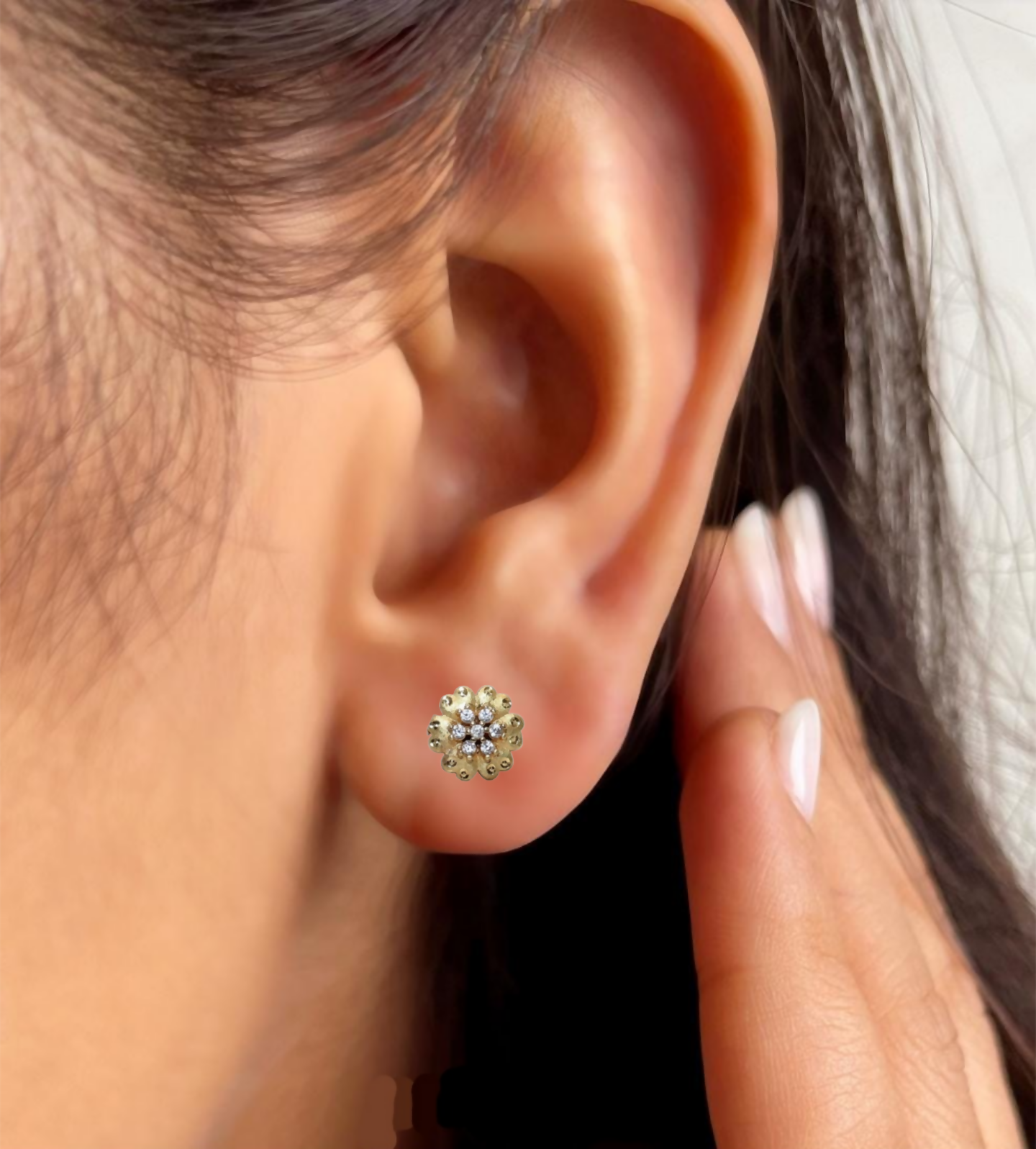 Side view of elegant gold plated floral stud earrings with push-back clasp