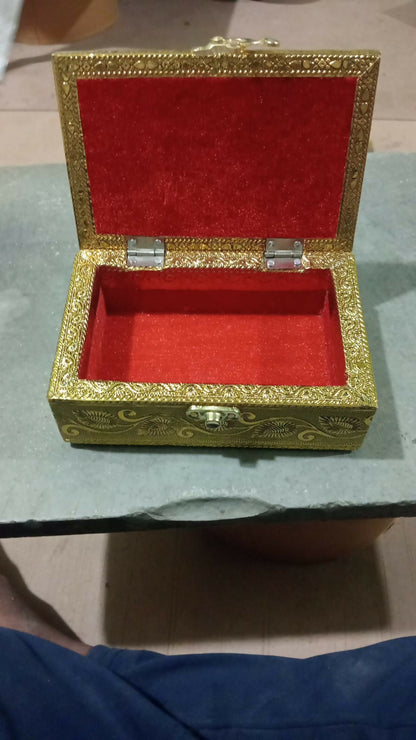 Open brass jewelry box showing interior storage space