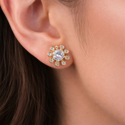 Gold finish flower design stone stud earrings front view showcasing shining stones