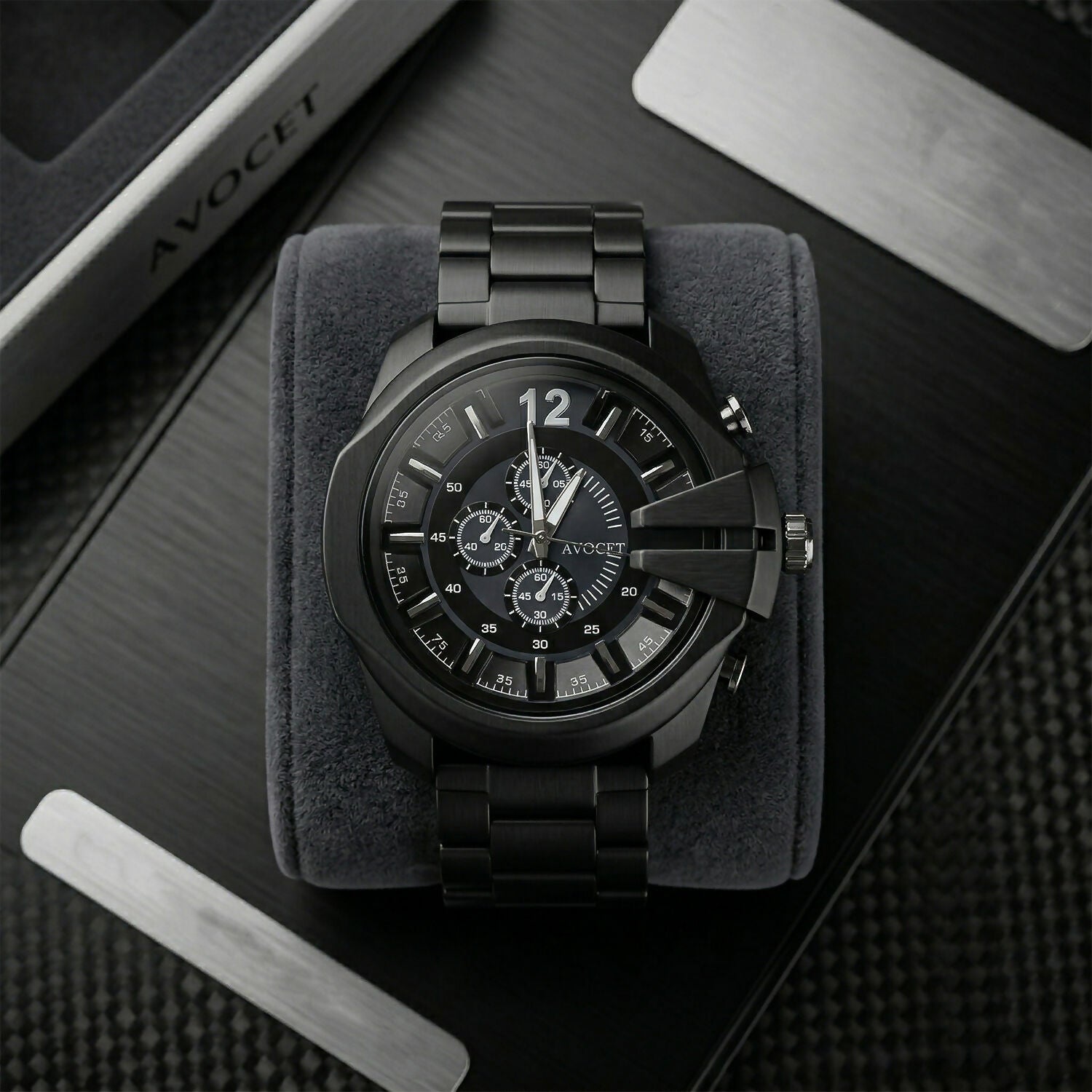 Black chronograph wrist watch on wooden surface