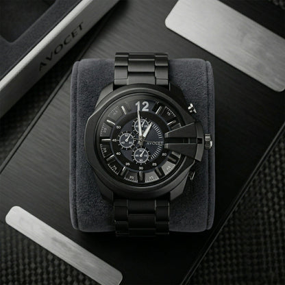Black chronograph wrist watch on wooden surface