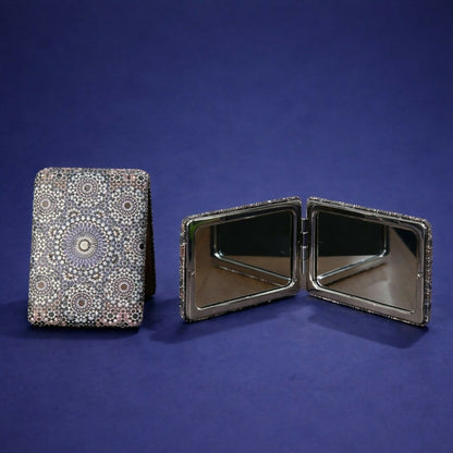 Open compact foldable pocket mirror showing dual mirrors