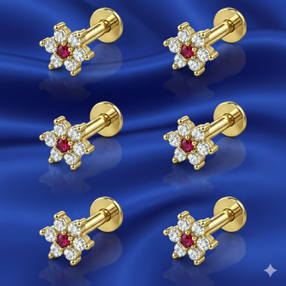 Close-up of ruby floral stud earring with gold plating and white zirconia accents