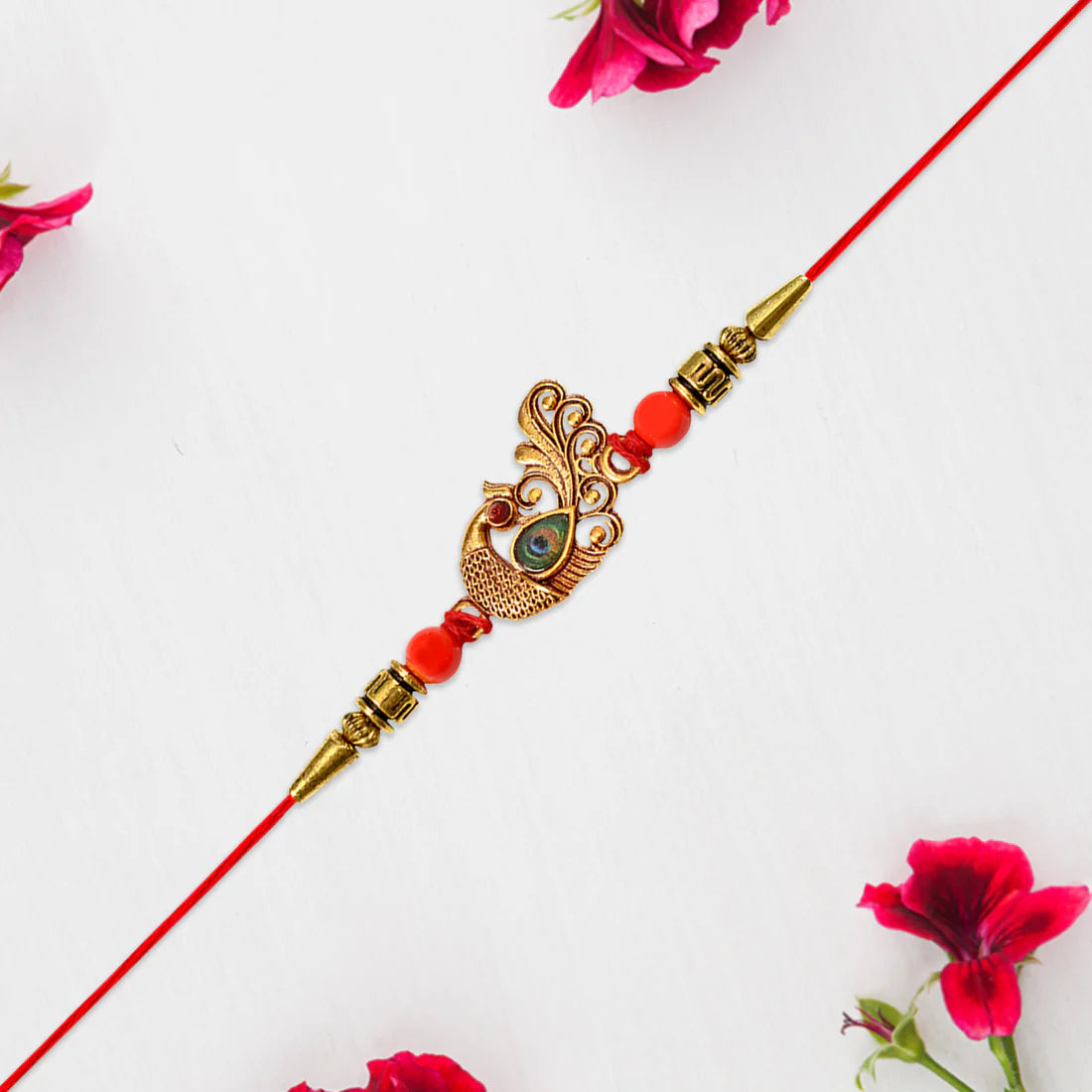 Handcrafted Peacock Rakhi showcasing intricate golden stonework and bead detailing.