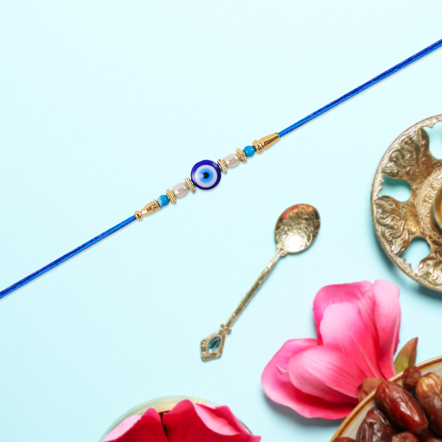 Stylish Blue Thread Rakhi with Central Stone, Pearl Beads, and Golden Detailing – Elegant Bracelet for Raksha Bandhan