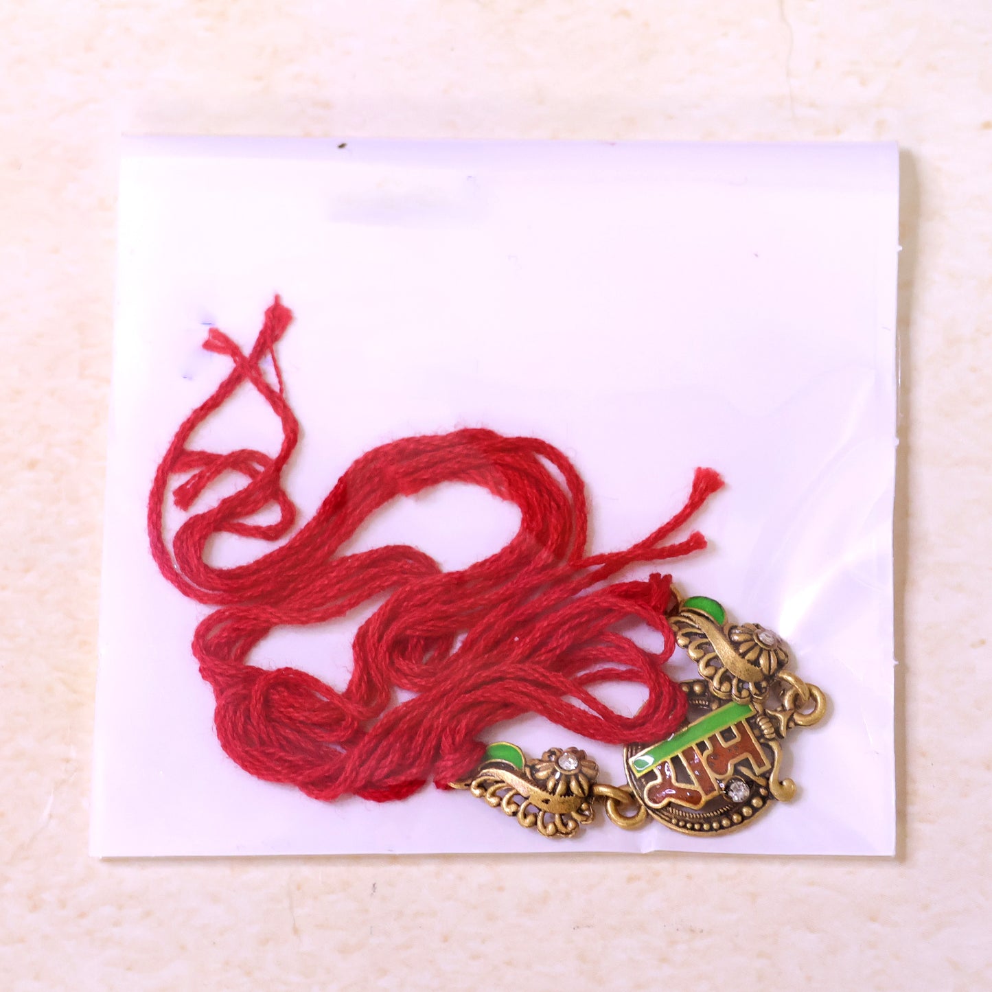 Antique Gold-Toned Ram Rakhi with Crystal Accents, Green Enamel & Designer Red Thread