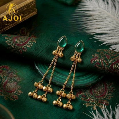 Detailed shot of a single green teardrop stone earring with ghungroo bells