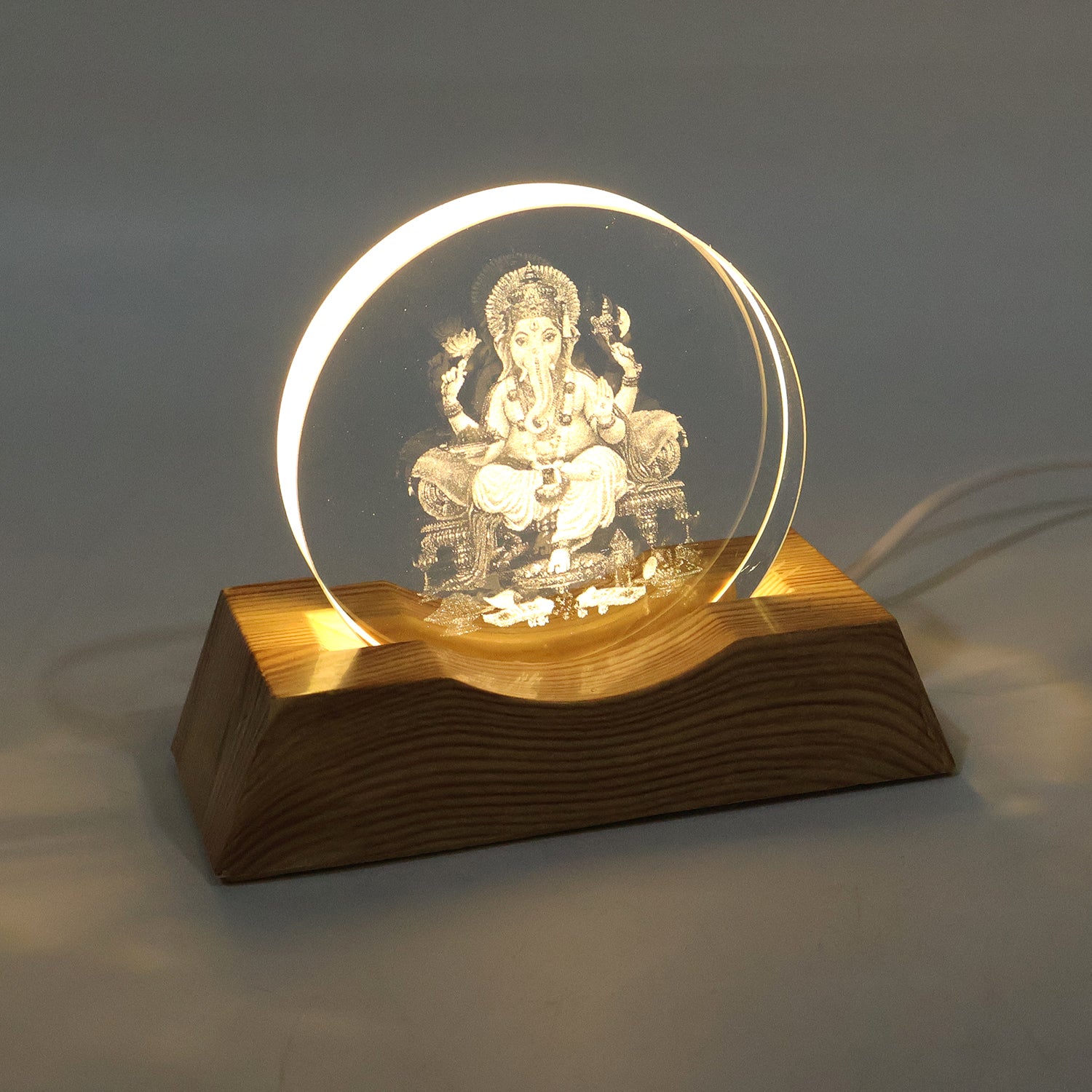 3D Lord Ganesha LED lamp glowing with warm light in dark room