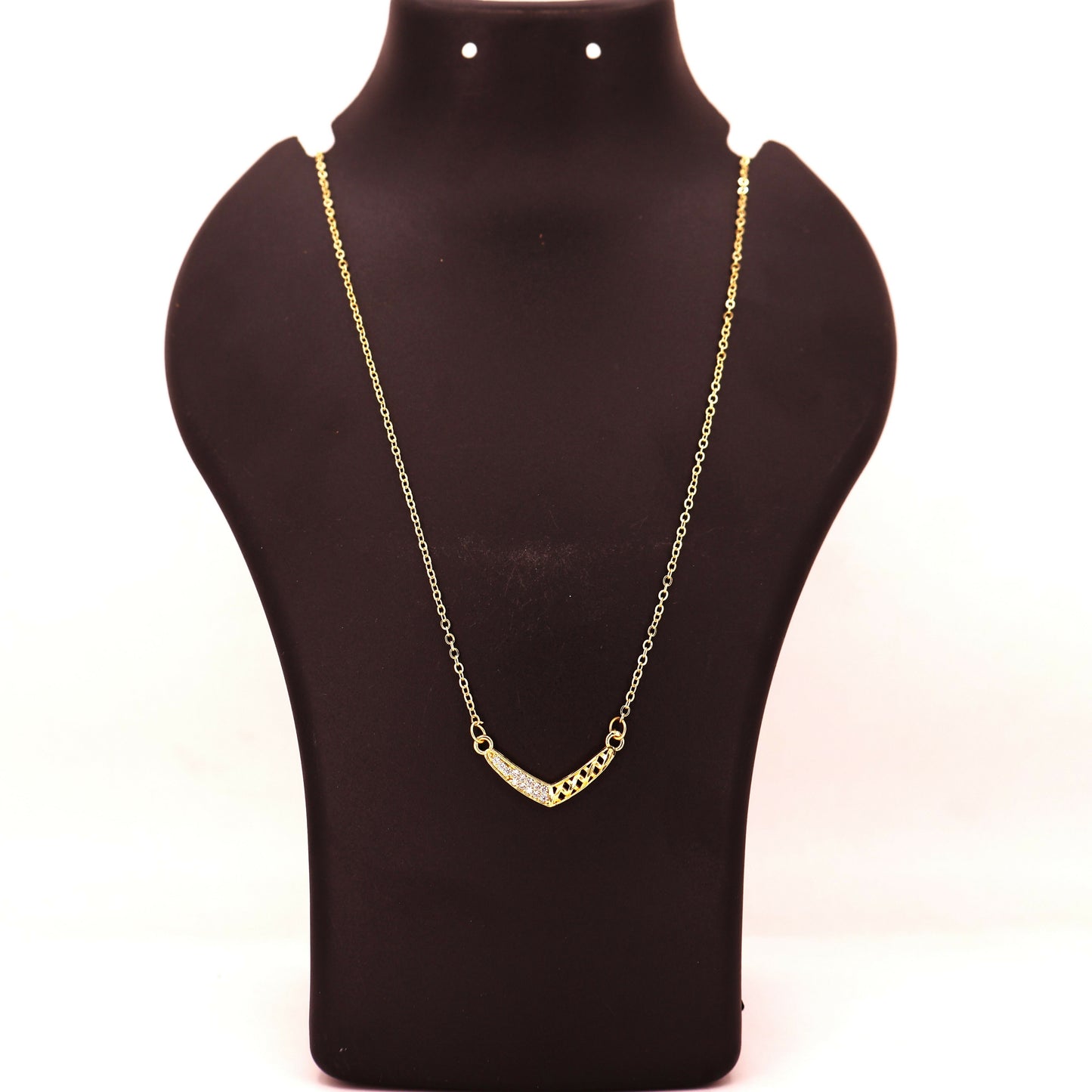 Model wearing gold plated V-shape necklace with pink-tinted pavé crystals