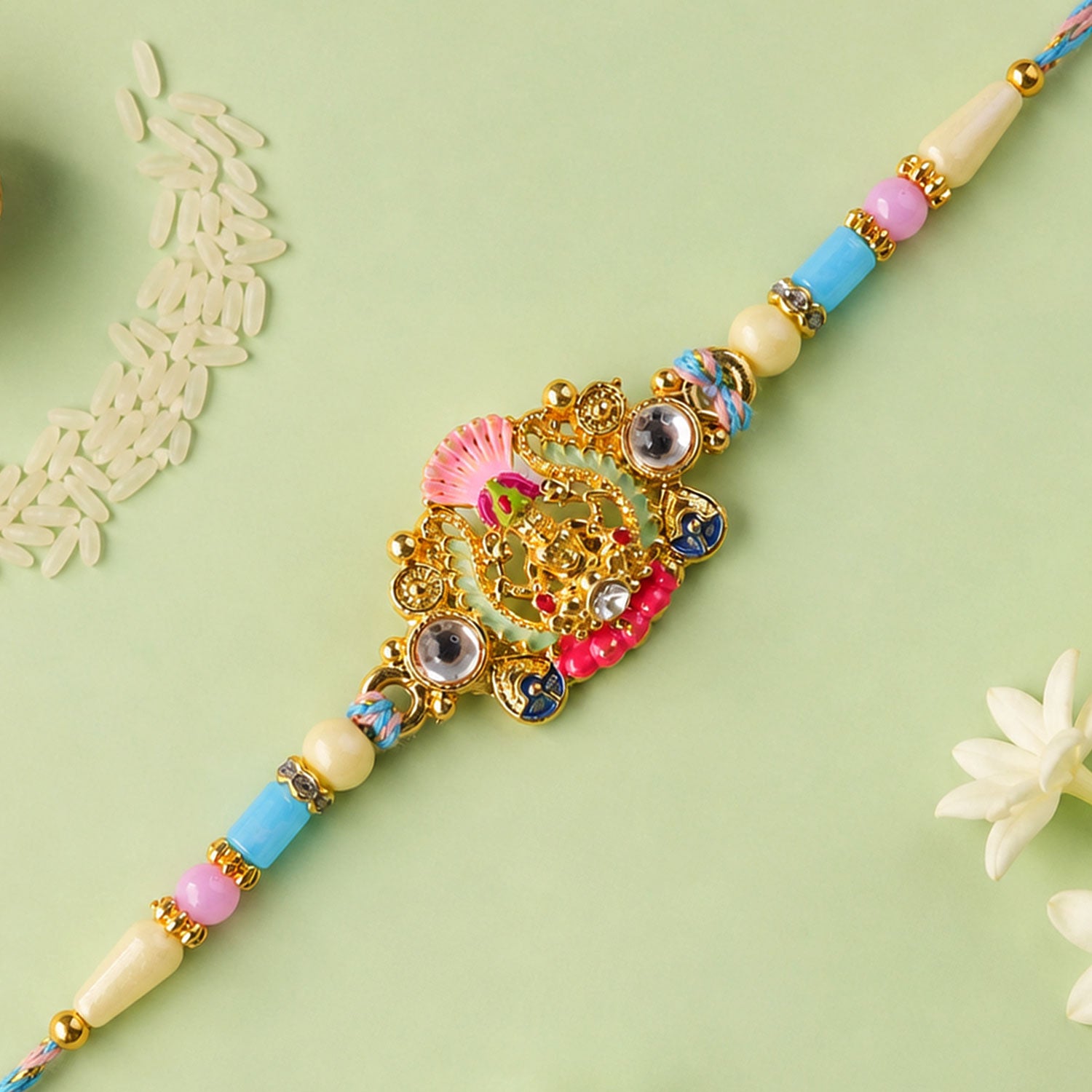 Gold Peacock Kundan Pendant Rakhi with Pastel Beads