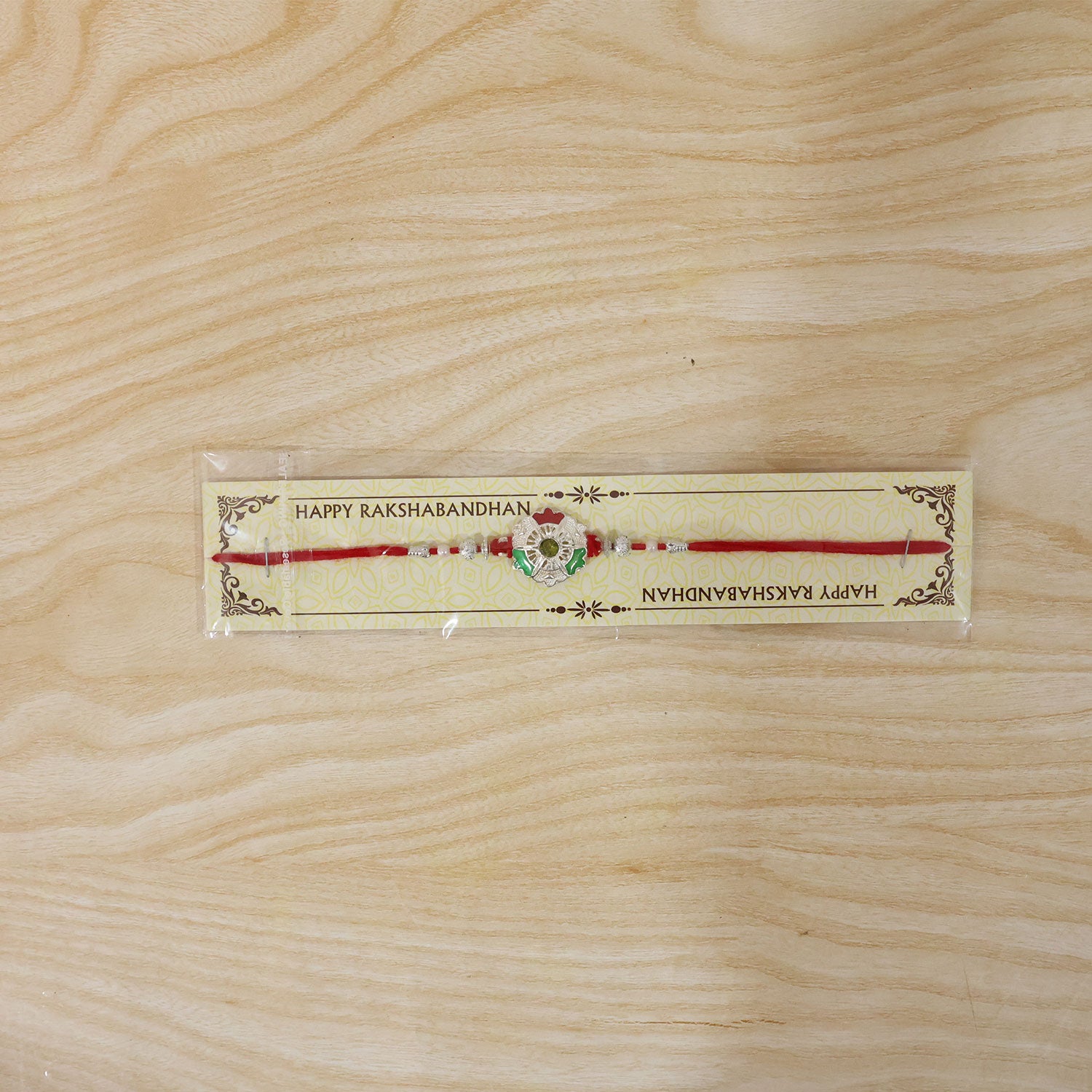 Green White Flower Rakhi with Silver Beads and Red Thread