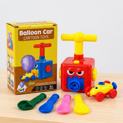 A red pump, yellow car with no balloon, and four deflated balloons sit beside a product box.