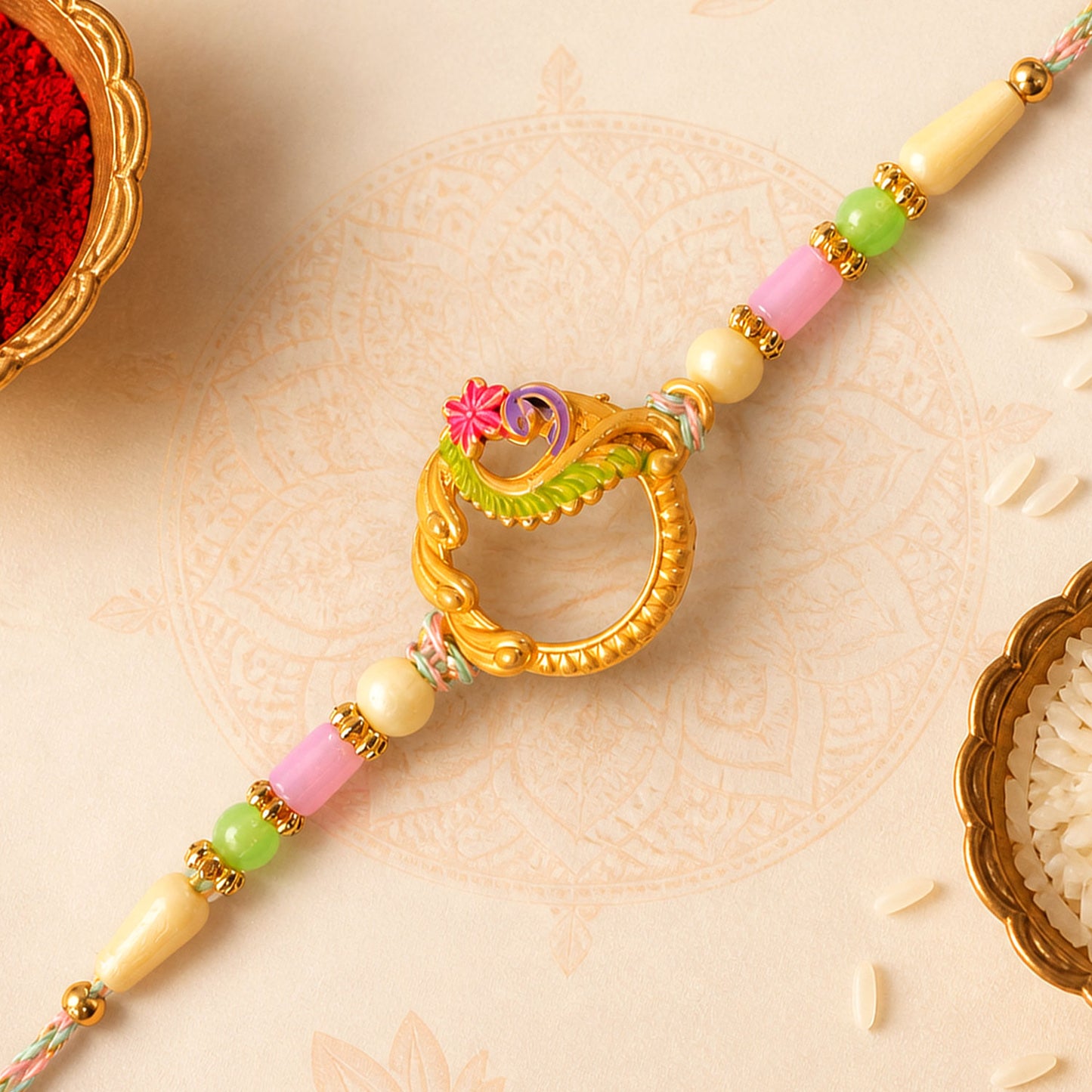 Golden Circular Rakhi with Pink Green Beads and Refined Festive Brother Gift Appeal