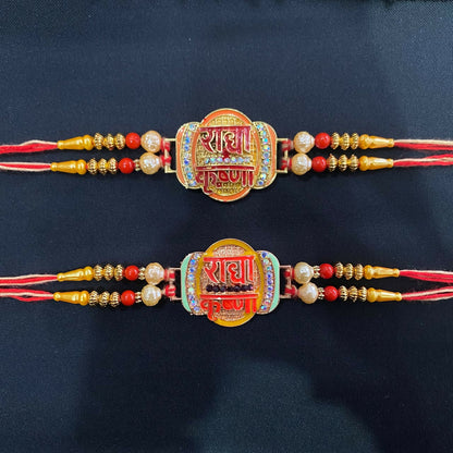 Two matching Rakhi bracelets, each showcasing a gold-colored oval with red Hindi script, surrounded by small clear stones,