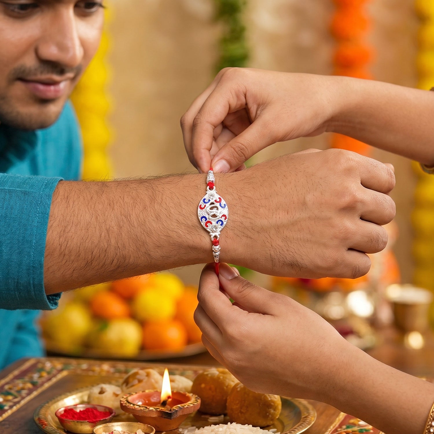 Silver Om Rakhi for Boys with Red Thread and Colorful Accents