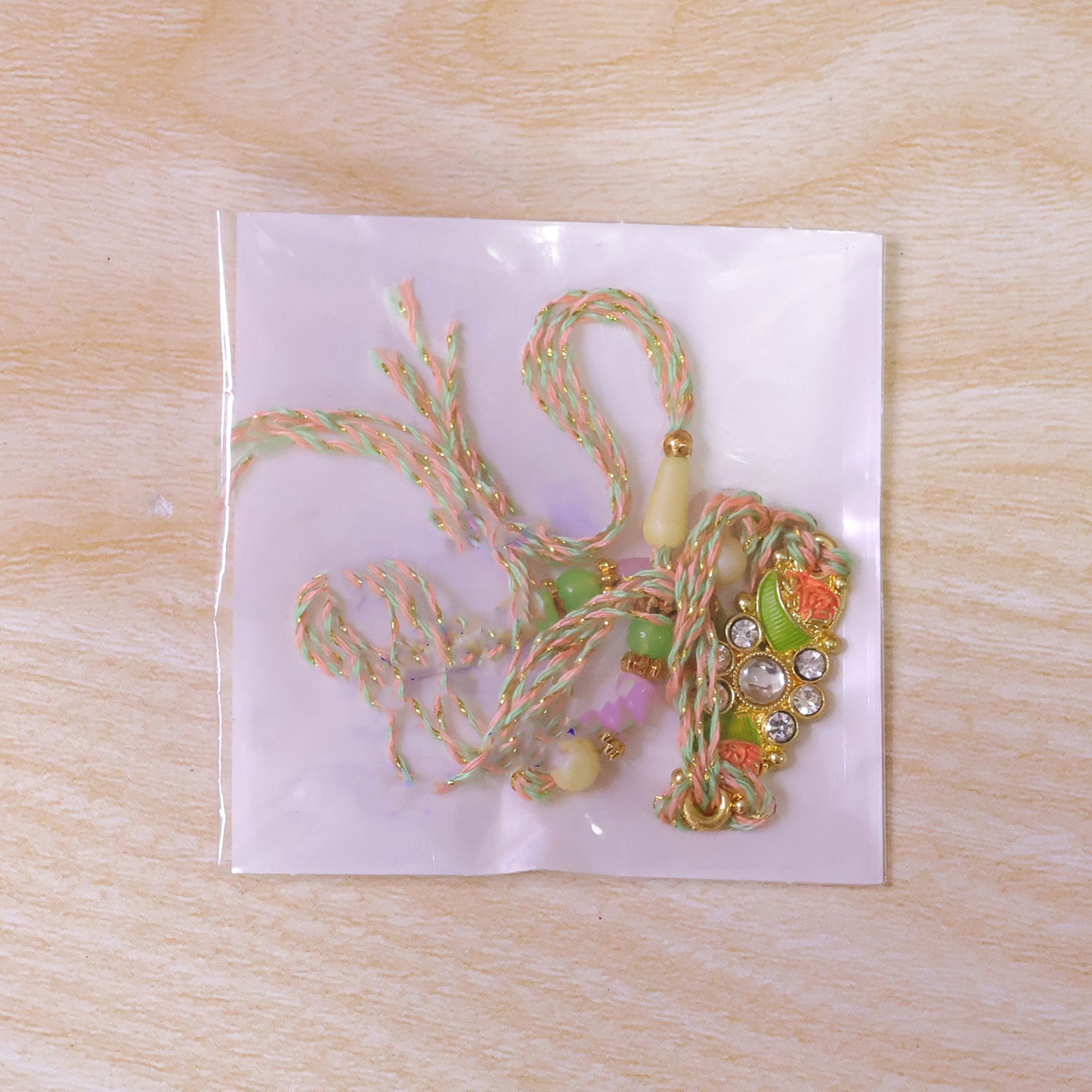 Ornate Rakhi featuring Floral Mirror Medallion, bead line and chain look for Gift Use