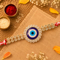 Premium Rakhi showcasing Evil Eye Charm, leaf touch and thread look for Gift Use