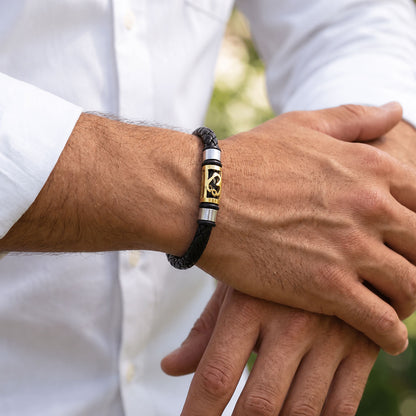 Sacred Symbol Rakhi with Black Braided Band and Gold Plaque for Raksha Bandhan Gift