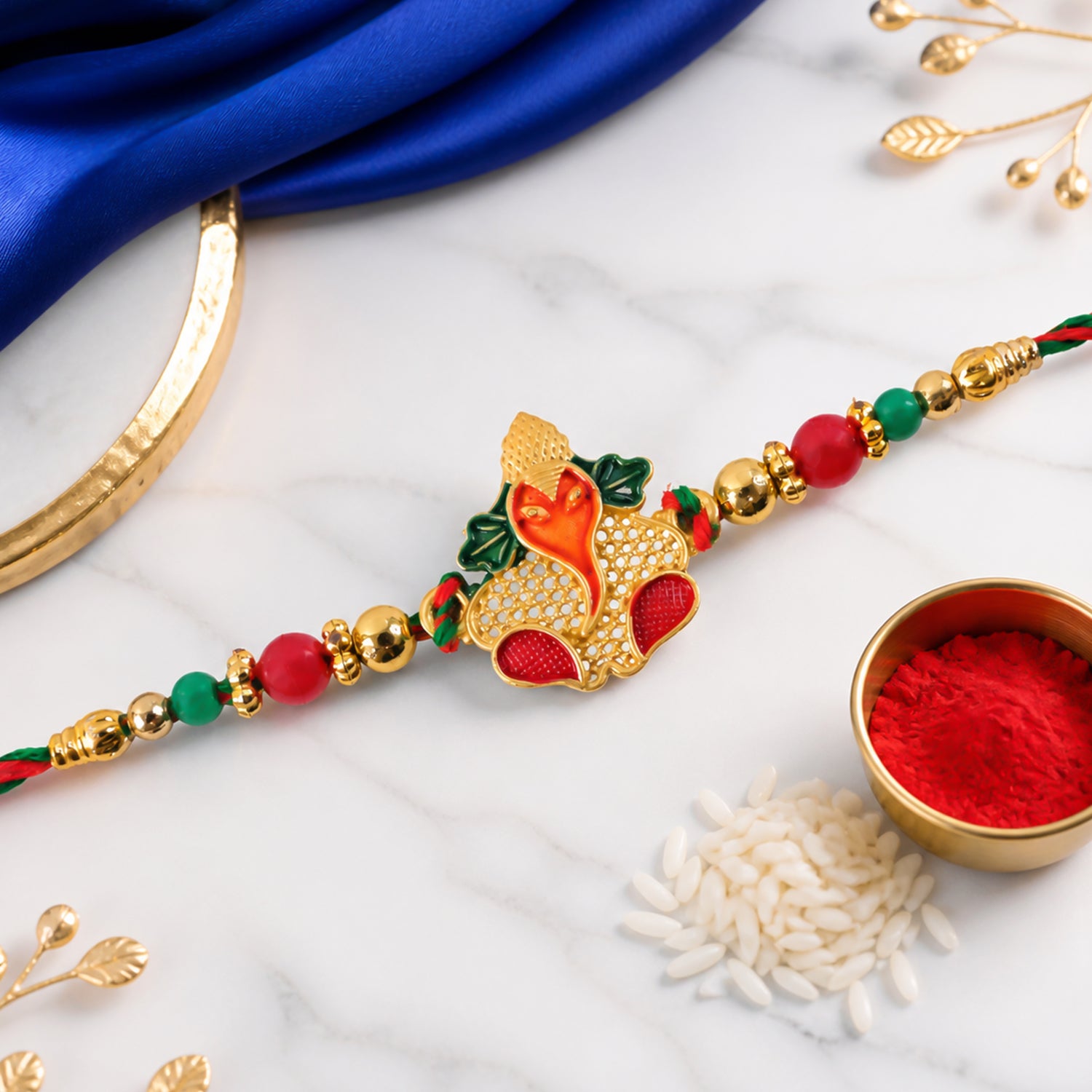 Gold Ganesha Pendant Rakhi with Red and Green Enamel