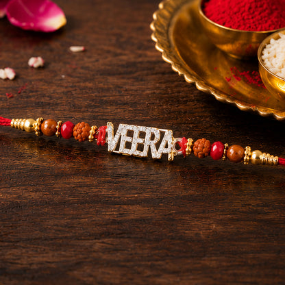 Veera Name Golden Designer Rakhi with Red Stones, Pearl Accents and Festive Beads