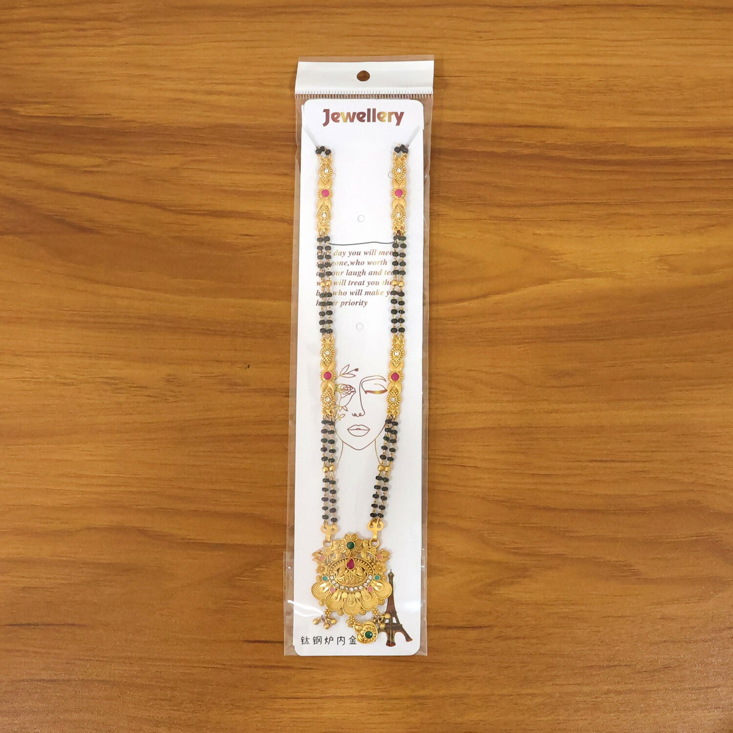 Front view of the floral lotus pendant highlighting pink enamel petals and gemstones'}],