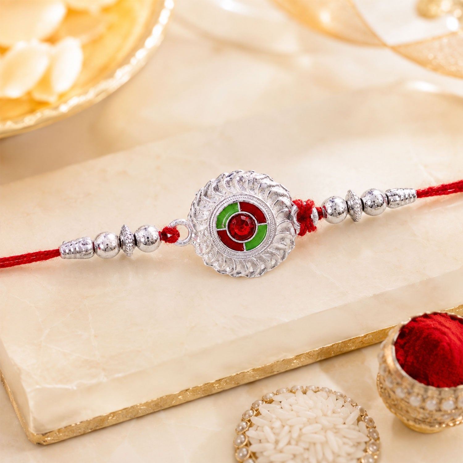 Silver Round Kundan Rakhi with Green Red Center and Metal Beads
